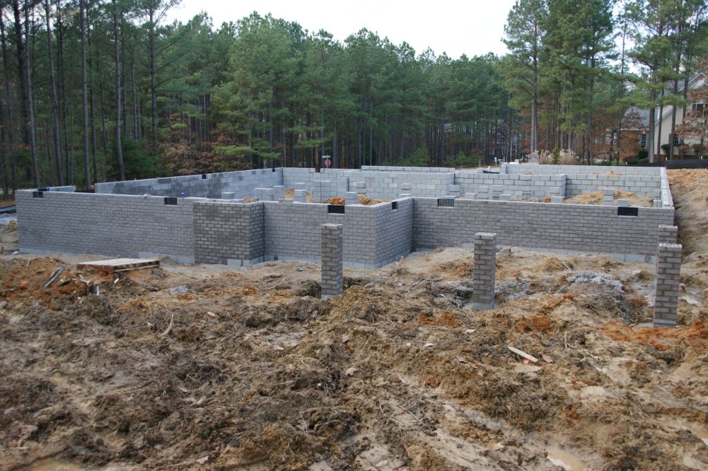 Back of house with fireplace and supports for covered deck